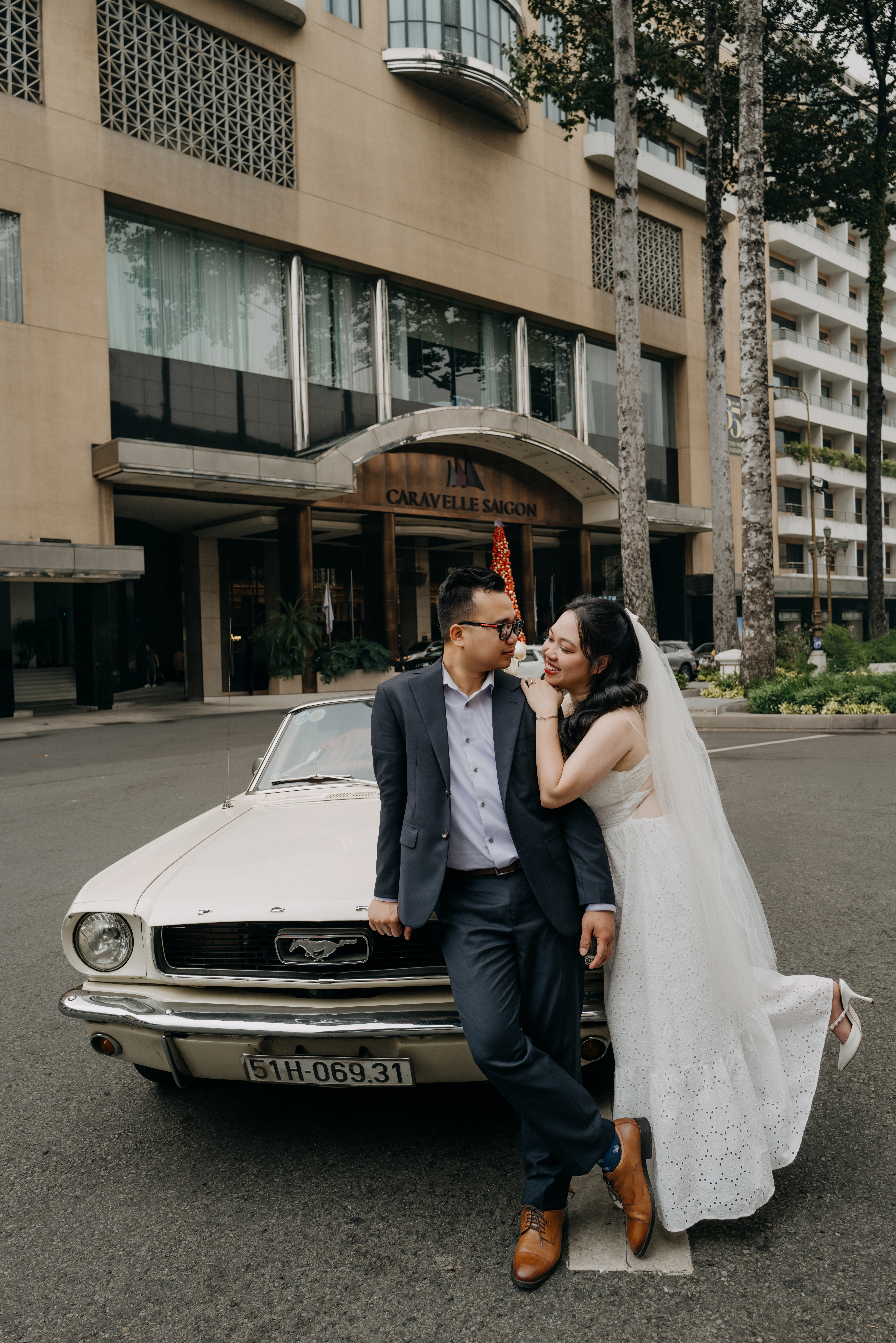 Merry and Quan smiling together near the sea
